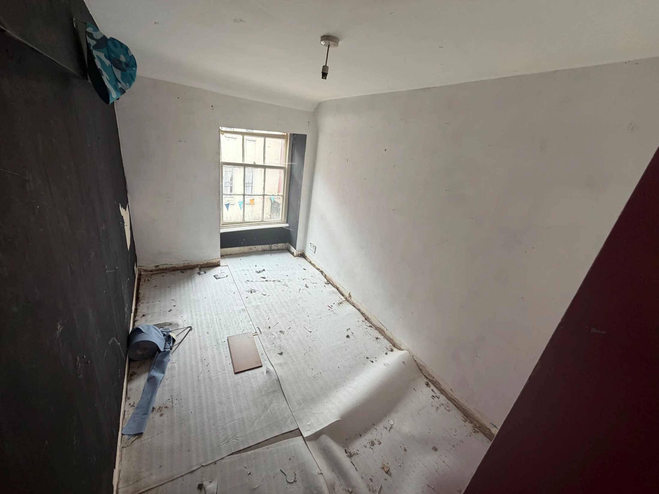 A vacant upstairs bedroom with a sash window